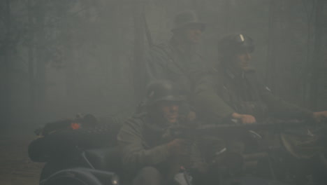 german soldiers on motorcycle in foggy forest