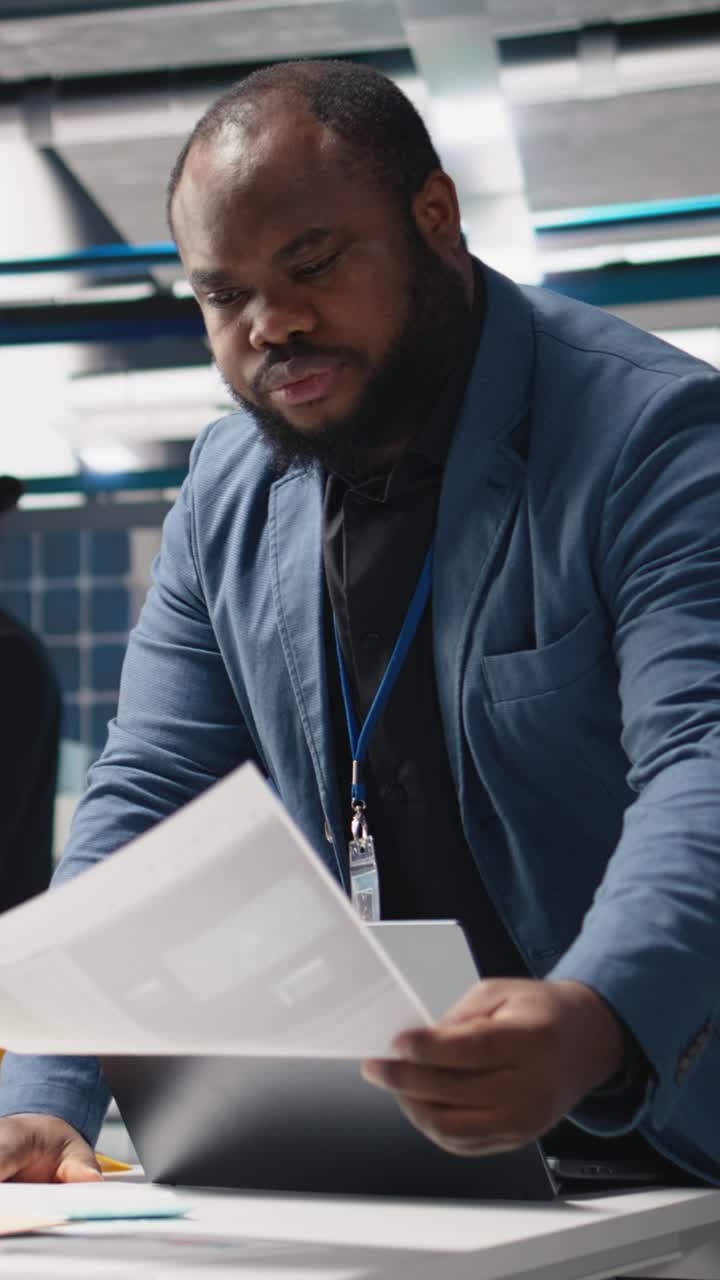 Vertical Video Black solar panel engineer in a high tech facility doing an inspection