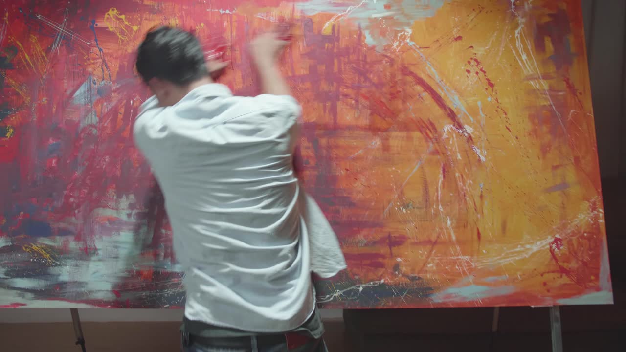 Male Artist Draws With His Hands On The Large Canvas, Using Hands Creates Colorful, Emotional, Sensual Painting. Contemporary Painter Creating Abstract Modern Art