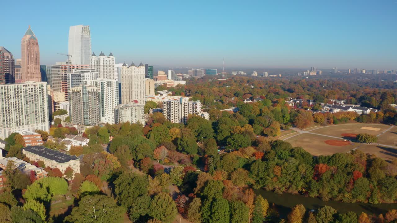 Flying over Piemont Park and recreation quad towards downtown Atlanta Georgia in the Fall