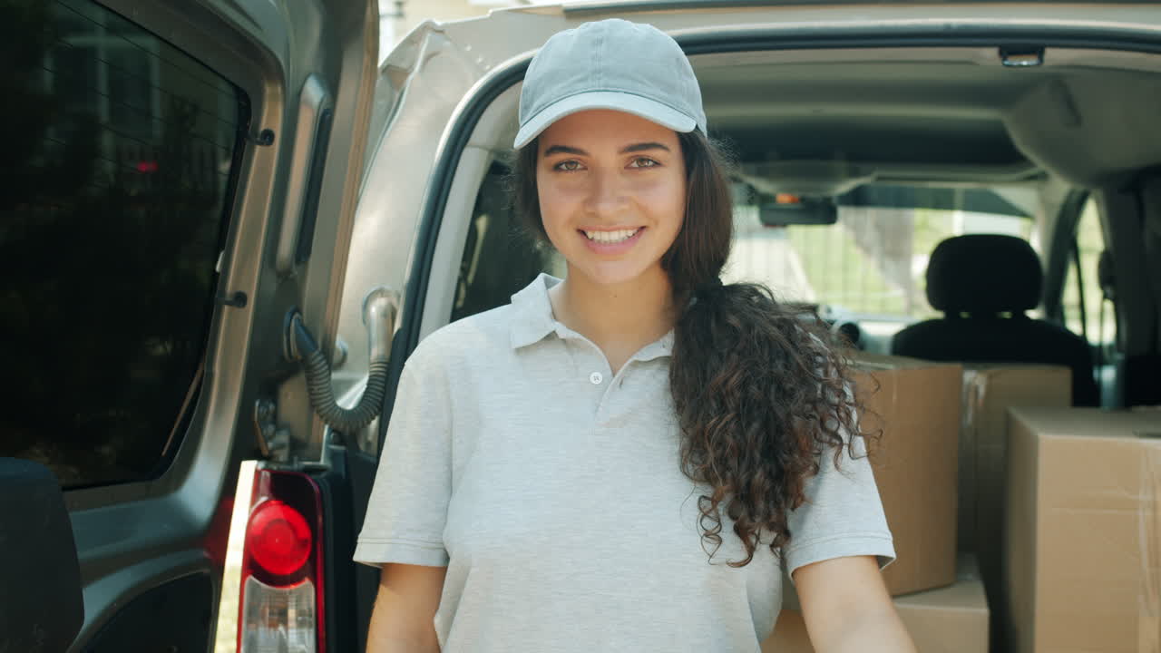 Woman Delivery Driver Loading Van