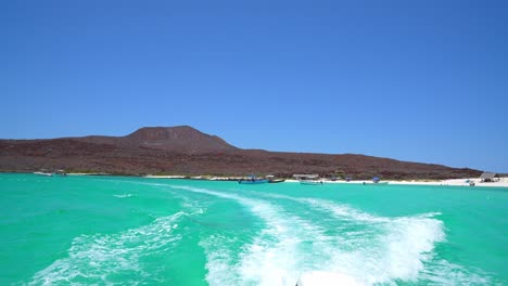 Beautiful-turquoise-water-crystal-clear-with-volcano-in-the-background,-Isla-Coronado,-Loreto,-Baja-California-Sur