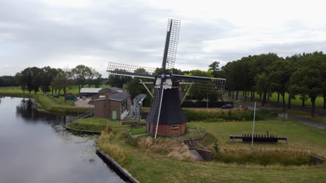 aerial view in orbit over a water mill in the town of de groeve, the netherlands