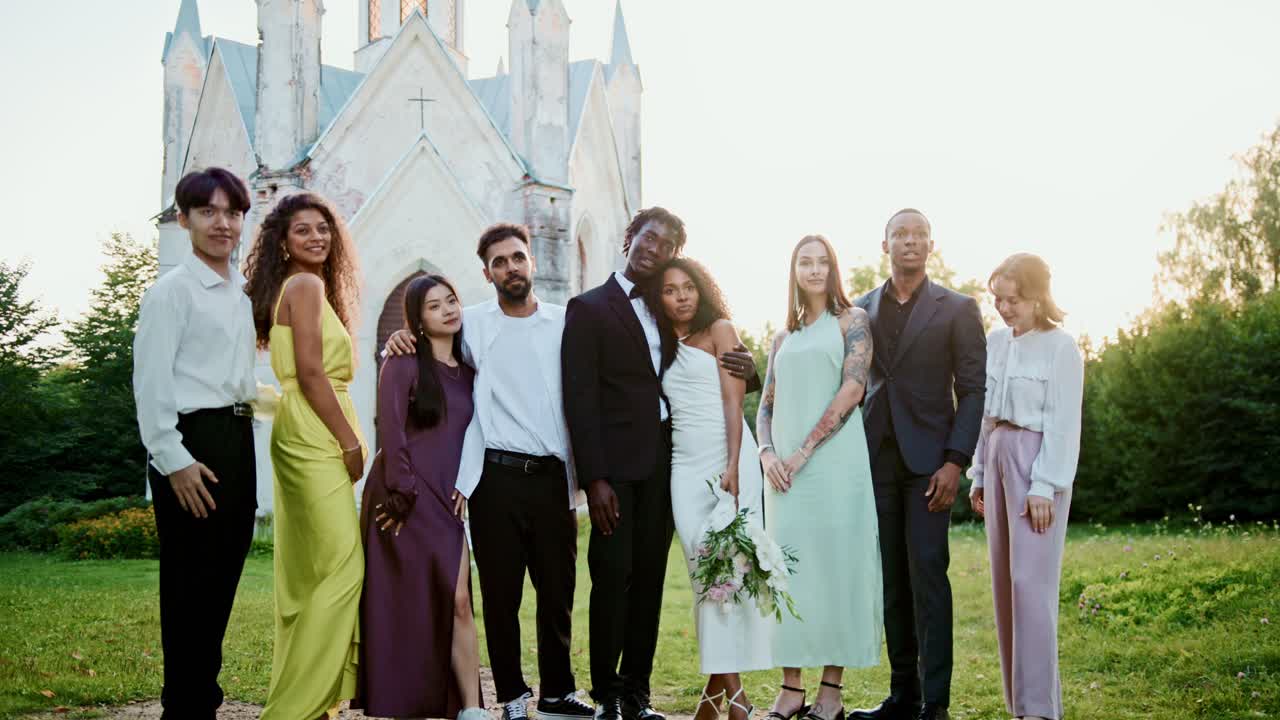 Wedding party posing in front of a building