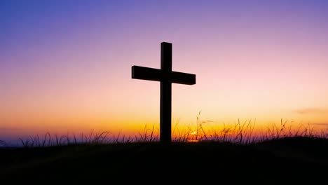 wooden cross stands silhouetted against a vibrant sunset sky, creating a serene and inspirational scene of faith and hope