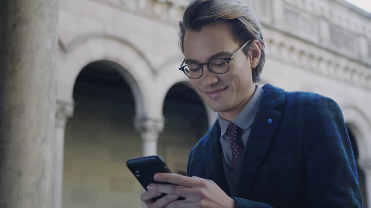 Smiling student using smartphone