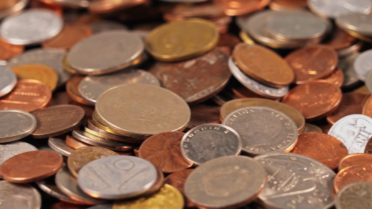 Coins scattered on a surface showing various sizes and shapes