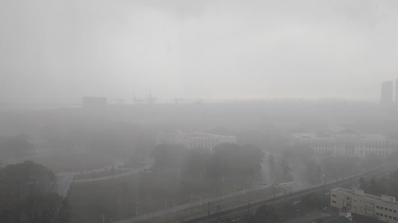 Aerial view of torrential rain downpour and poor visibility over capital city metropolis of Manila Philippines