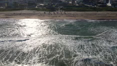 Drone-shot-of-big-waves-and-the-beach-of-Praia-Brava-in-Brazil