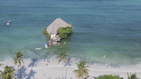 zanzibar rock restaurant aerial dolly view across paradise turquoise coastline in tanzania africa