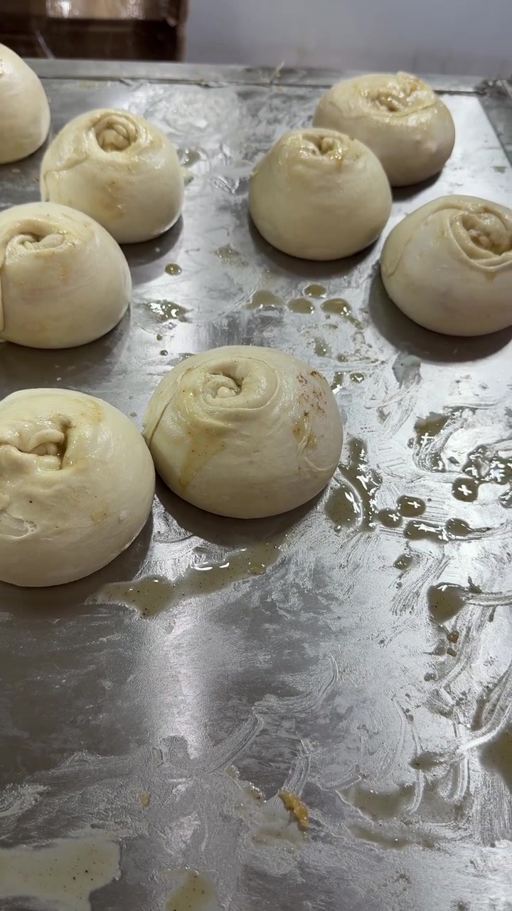 Fresh Dough Balls Resting on a Metal Tray in a Bakery