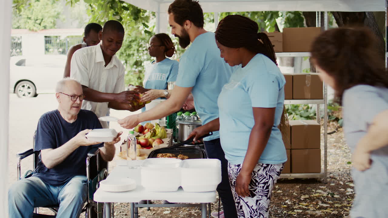Volunteers Assist The Disabled With Food