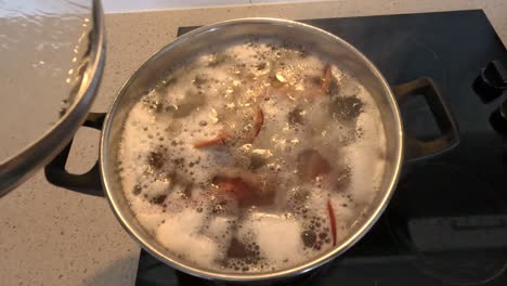 boiling pasta with seasoning in pot