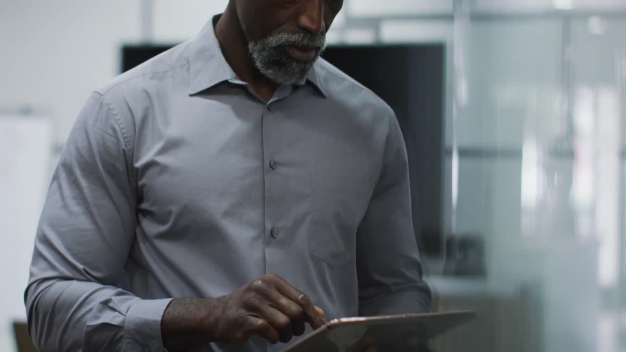 African american businessman using digital tablet in office