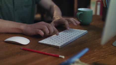 man typing text on modern keyboard