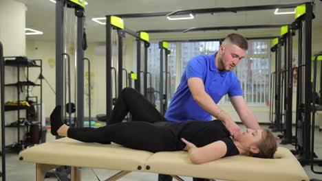 physical therapist assisting patient with back exercises
