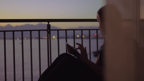 Young-woman-on-a-balcony-against-sea-scenery