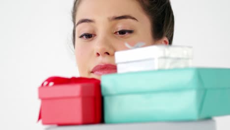 mujer sosteniendo bolsa de compras con una pila de cajas de regalos