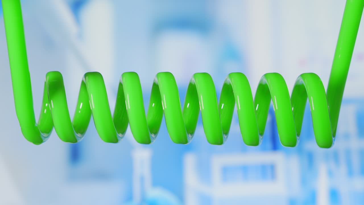 Close up and slow motion of green colored liquid spiraling in scientific glass condensers. Development of new drugs and medicinal compounds. The search for a vaccine against coronavirus