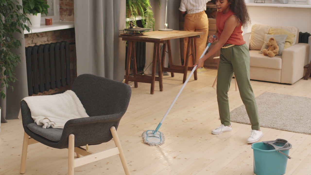 Mom And Daughter Cleaning Apartment Together