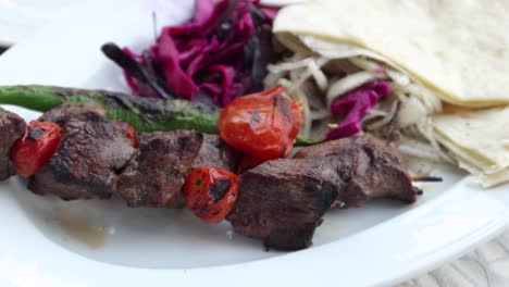 seekh kabab, bread, and sauce on a plate