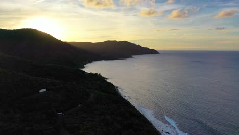 aerial view of a radiant sunrise in st. croix, with early light shimmering off the ocean, a forested point reaching into the bay, and the peaceful rhythm of morning along the shoreline