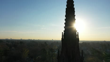 an aerial shot of a cathedral's steeple, which was taken at sunrise