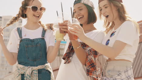 teenage girls enjoying drinks outdoors