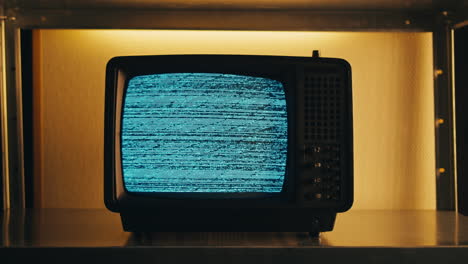 retro tv, vintage television in a nostalgic setup, a retro tv displays grain on screen, scary halloween night device good for chroma key and green screen.