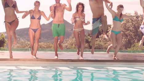 happy friends diving together in the pool