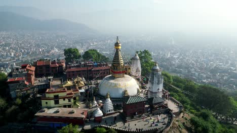 aerial landscape view of swayambhunath temple, ancient buddhist stupa with hanging prayer flags, with kathmandu, nepal, in the background