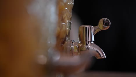 a stationary shot of a juice pitcher's faucet