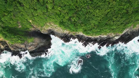 shore of the pacific ocean in zihuatanejo, mexico. where waves crash against the rocks and the jungle grows over them. 4k drone shot of the pacific ocean