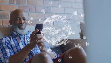 animation of network of connections and globe over african american man using smartphone