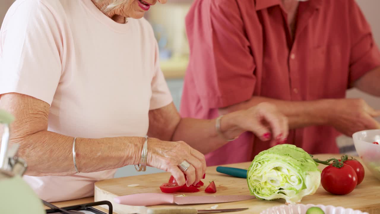 Senior couple preparing food together in the kitchen
