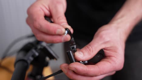 Daily-life-of-bicycle-mechanic---installing-lever-for-dropper-post-on-a-mountain-bike