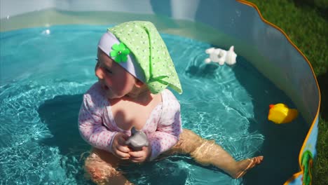 baby playing in a pool