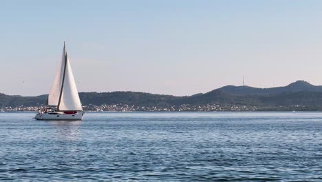 Sailboat-slowly-sailing-on-a-calm-Adriatic-Sea-in-Zadar,-Croatia