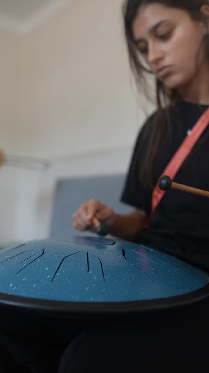 Woman Playing Singing Bowl