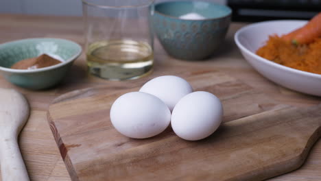 three pieces of eggs placed in wooden chopping board