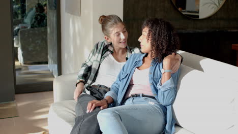 relaxing on couch, lesbian couple enjoying quality time together at home