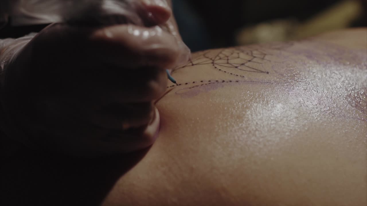Tattoo Artist Working on a Spider Web Tattoo
