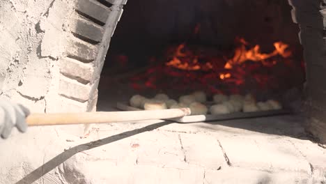 cooking bread in clay oven traditional bakery of pastry in slow motion