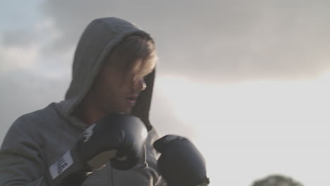 man boxing in the park in the evening sun - ungraded