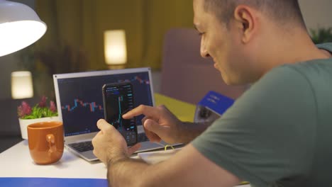 man doing financial trading on the phone. graphic analysis.