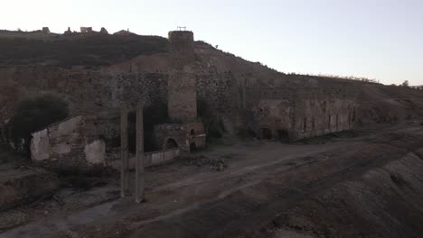 Ruined-buildings-near-Sao-Domingos-Mine-in-Portugal,-drone-aerial-view