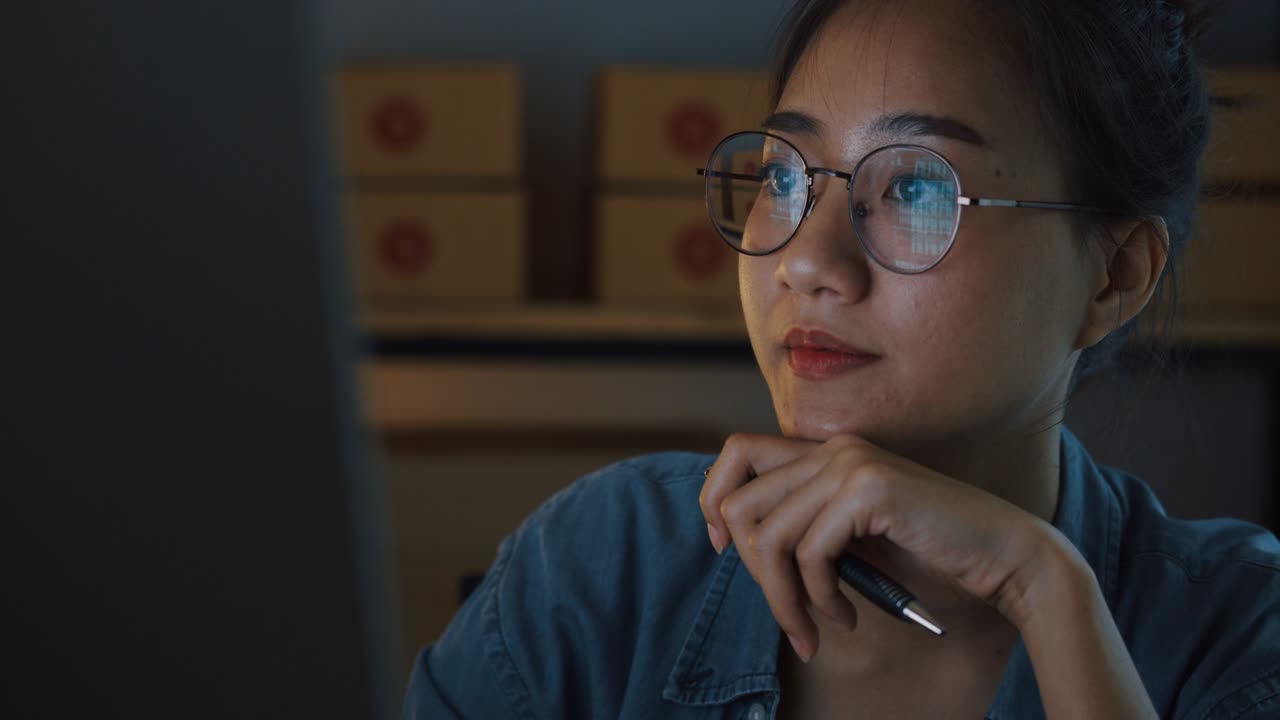 Asian girl are working sitting and smiling while using computer at night, Small business concept