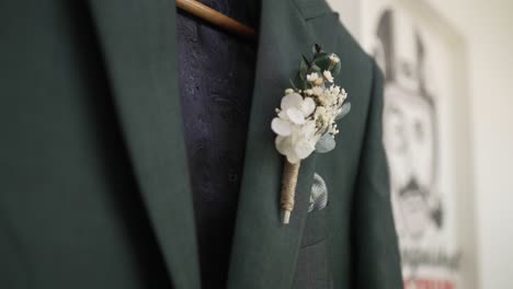 elegant green groom suit with dried flower boutonniere