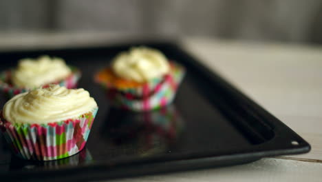 Cooking-cupcakes.-Hand-put-cup-cake-on-baking-tray.-Homemade-cupcakes