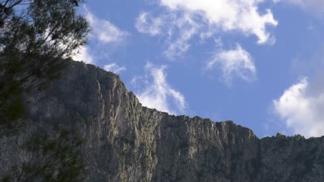 white clouds moving over rocky ridge